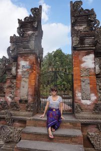 Myself sat in between a Balinese doorway at Tirta Empul, Bali.