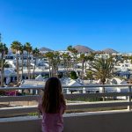 Girl looking at view from balcony of mountain views in Lanzarote