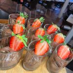 A close up shot of chocolate mousse desserts with strawberry on top at Sol Lanzarote restaurant.